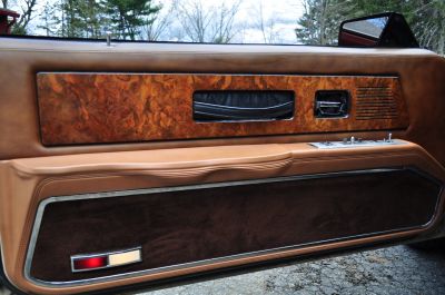 English walut trim  and leather pull straps on the doors
