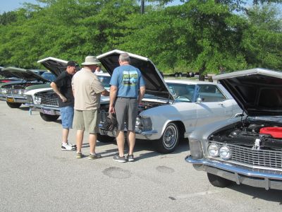 Admiring an engine wearing a meet shirt
Enjoying the Show
